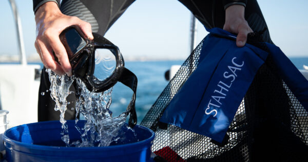 Diver cleaning mask, lifestyle image